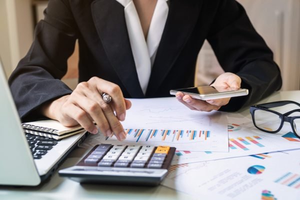 Businesswoman working on Desk office with marketing graph statistics analysis