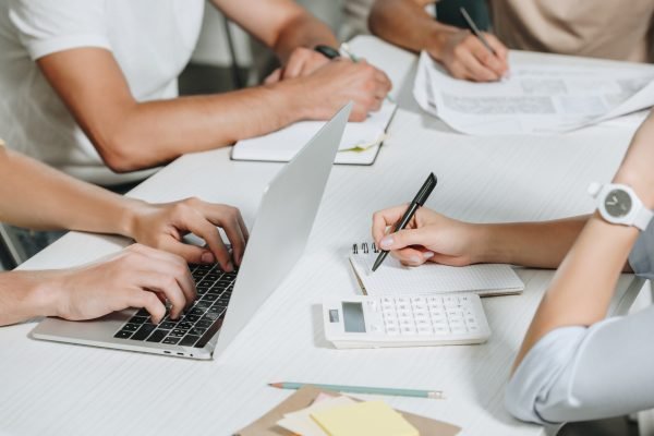 cropped image of businesspeople working at table in office